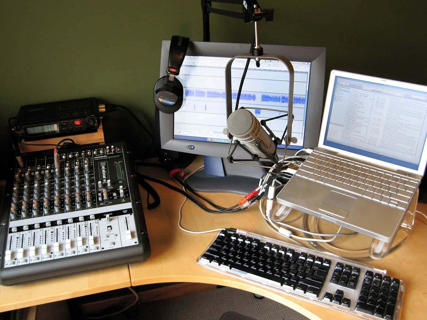 A home podcast studio with microphones, headphones and a computer